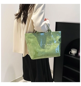 Detail of green Tyvek tote bag with waterproof coating and white TOTE BAG text print
