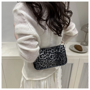 Detail of leopard print shoulder bag with silver beaded trim and metal chain strap