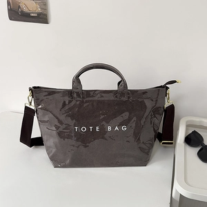 Glossy coffee brown patent leather tote bag with TOTE BAG print and adjustable strap