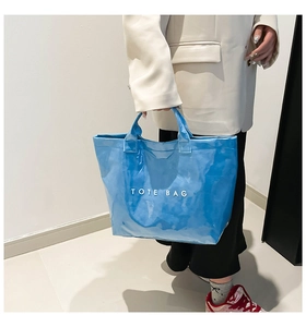 Detail of bright blue Tyvek tote bag with white lettering for casual daily use