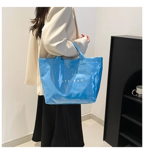 Blue waterproof Dupont paper tote bag worn by a model against a minimalist background