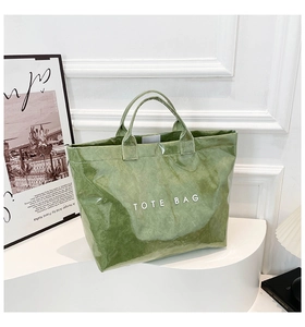 Detailed view of a green waterproof DuPont paper tote bag with unique crinkle texture