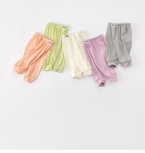 Detailed macro shot of ribbed elastic kids pants in five Morandi colors with Bear labels