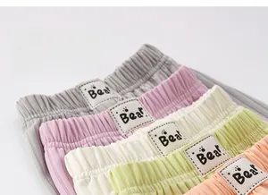 Detail showing elastic waistband with 'Bear' woven label on soft ribbed fabric pants