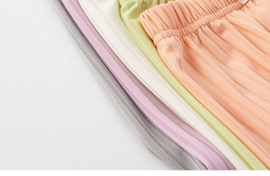 Close-up of colorful ribbed knit elastic waistbands on kids' mosquito pants