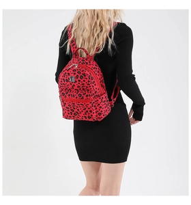 Rear view of a model wearing the red leopard print mini backpack with silver metal plate