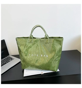 Detail showing the grass green DuPont Tyvek tote bag with white TOTE BAG text print