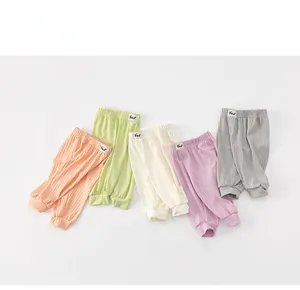 Detail view of five pairs of pastel ribbed mosquito pants with Bear labels for kids