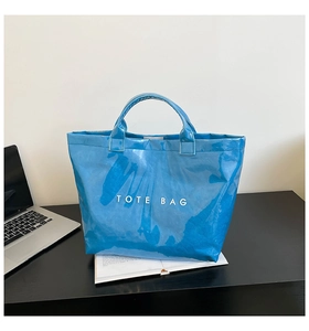 Glossy blue waterproof DuPont paper tote bag with white text for office commute
