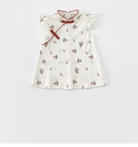 Detail of girls' traditional cheongsam dress with cherry print and ruffle sleeves