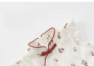 Detail of Chinese style kids dress with red frog buttons and floral pattern fabric