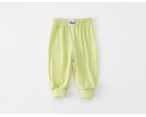 Detail of light green striped toddler pants featuring a comfortable elastic waist and bear label