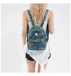 Rear view of model wearing a tropical leaf print backpack with large capacity