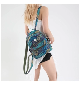Rear view of tropical leaf print backpack with adjustable straps on white background