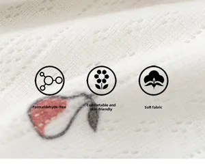 Macro shot of soft white breathable knitted fabric with red and white strawberry pattern