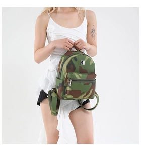 Detail of female model wearing the camouflage backpack with green patterns and metal logo