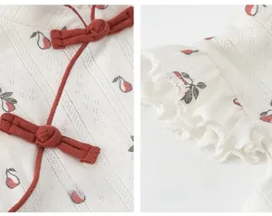 Detail of Chinese knot buttons and floral lace sleeves on a cotton girl's qipao dress