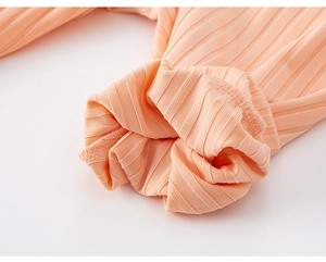 Macro shot of apricot knit ribbed cuffs with fine stitching for kids mosquito pants