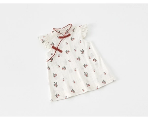 Detail of traditional Chinese knot buttons and cherry print on girl's summer qipao dress
