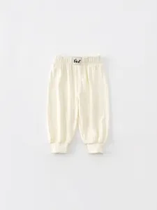 Infant cream ribbed knit joggers with elastic high waist and bear patch detailing