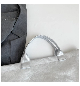 Detailed shot of the silver metallic DuPont paper tote bag with reinforced handles