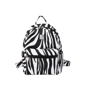 Classic zebra print backpack with multiple compartments and metallic branding tag