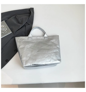 Close-up of metallic silver tote bag with crinkled texture for modern daily commuting