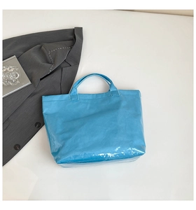 Detail of blue waterproof DuPont paper tote bag with unique glossy crinkle texture and handles