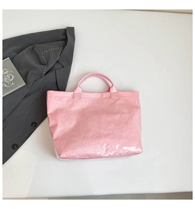 Detailed view of pink glossy crinkled tote bag with premium patent leather texture