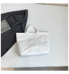 Minimalist white Tyvek tote bag with natural wrinkled texture on a neutral background