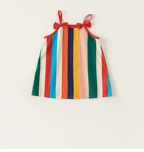 Detail view of colorful vertical stripes and cute red bows on the girls summer dress