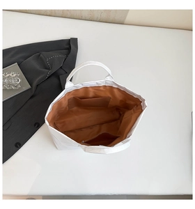 Top view of white DuPont paper tote bag showing spacious brown interior and zip pocket