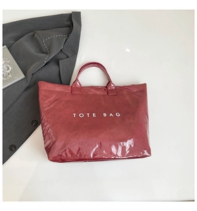 Red waterproof DuPont paper tote bag with TOTE BAG print and glossy finish details
