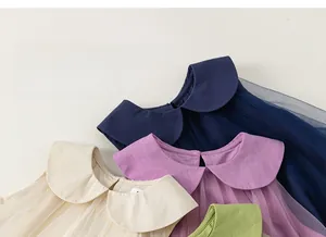 Detail of elegant Peter Pan collars on sleeveless tulle dresses in multiple soft colors