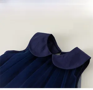 Close-up of a dark blue Peter Pan collar with pleated fabric texture and neat stitching