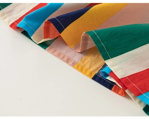 Detail of colorful striped summer dress with neat double-stitched hem and cotton fabric