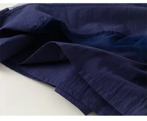 Detail of navy blue tiered dress hem showing fine stitching and layered mesh fabric