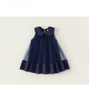 Detail of dark blue sleeveless tulle dress with Peter Pan collar and layered hem