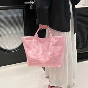 Minimalist pink waterproof tote bag with shiny wave texture and white text logo