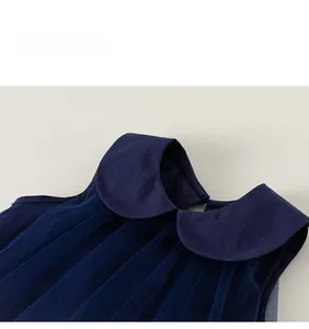 Detail of navy blue girls' dress featuring a classic Peter Pan collar and soft mesh fabric