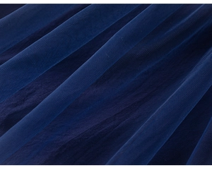 Close-up of deep blue layered mesh fabric with intricate lace texture for kids dress