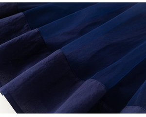 Detailed close-up of dark blue princess dress showing mesh fabric and stitching quality