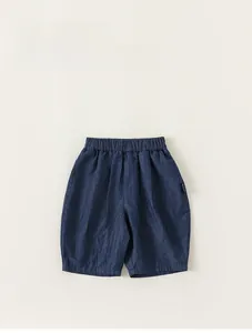 Flat lay of boy's summer denim shorts with comfortable elastic waistband in deep blue