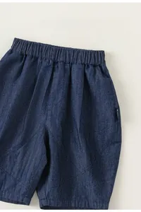Detailed macro view of comfortable elastic waistband on boys dark blue denim shorts