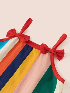 Rainbow striped girls sleeveless dress with red shoulder straps and delicate bow details