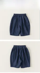 Front and back views of boys navy blue denim shorts with elastic waist and seam detail