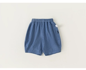 Close-up of boys denim shorts showing elastic waistband and detailed white side label
