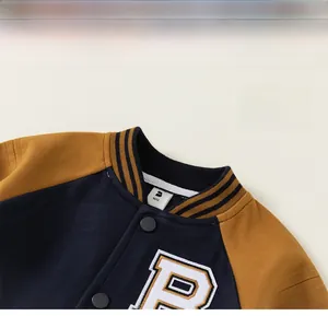 Detail of navy and yellow varsity jacket showing striped ribbed collar and letter R patch