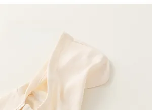 Gros plan sur la maille gaufrée du gilet à capuche beige pour enfant avec fermeture éclair
