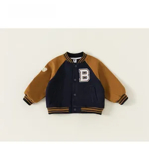 Detail view of boys athletic baseball jacket with contrast sleeves and letter B patch